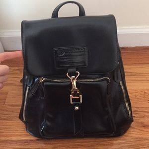 Black faux leather backpack with gold detailing